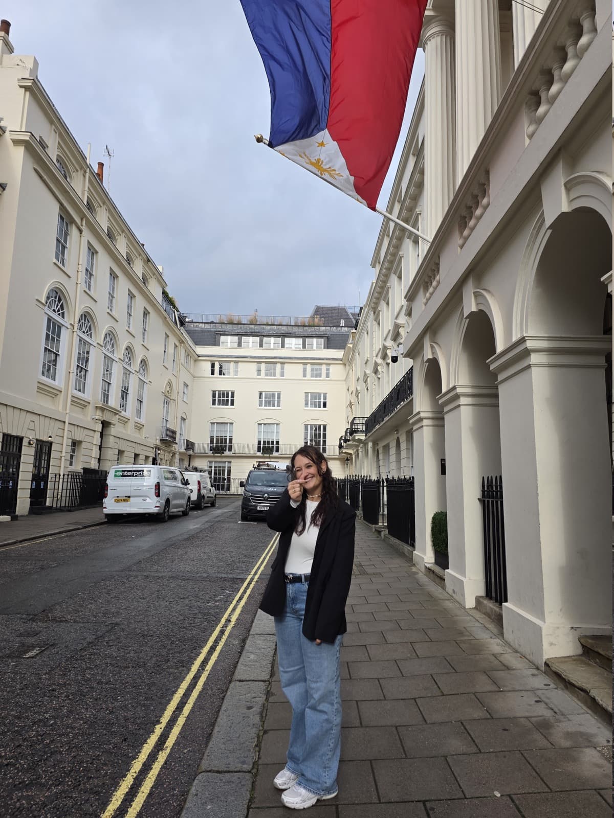 Vanessa in front of a Philippine flag